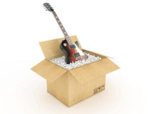 an open cardboard box with a guitar in it
